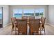 Cozy dining area with a waterfront view, complete with a wooden table and six woven chairs at 100 Bluff View Dr # 404C, Belleair Bluffs, FL 33770