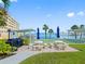 Outdoor picnic area with tables and a grill overlooking the waterfront at 100 Bluff View Dr # 404C, Belleair Bluffs, FL 33770