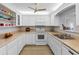 This well-equipped kitchen features modern appliances, white cabinets, and a breakfast bar that opens to the living room at 100 Bluff View Dr # 404C, Belleair Bluffs, FL 33770