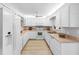 Bright, white kitchen with stainless steel appliances, wooden floors and lots of cabinet space at 100 Bluff View Dr # 404C, Belleair Bluffs, FL 33770