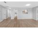 Light-filled living room with wood floors and a view into the bright kitchen at 100 Bluff View Dr # 404C, Belleair Bluffs, FL 33770