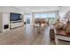 Spacious living room with modern furnishings and an open layout, featuring a dining area and waterfront views at 100 Bluff View Dr # 404C, Belleair Bluffs, FL 33770
