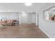 Inviting living room featuring wood floors, comfortable seating, and a pass-through to the kitchen at 100 Bluff View Dr # 404C, Belleair Bluffs, FL 33770