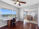 Office space with sliding door, wood floors, scenic views, and a ceiling fan at 100 Bluff View Dr # 404C, Belleair Bluffs, FL 33770