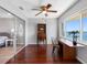 A bright office space with wood floors, water views, and adjacent room with glass door at 100 Bluff View Dr # 404C, Belleair Bluffs, FL 33770