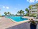 Beautiful outdoor pool with sun loungers and palm trees at 100 Bluff View Dr # 404C, Belleair Bluffs, FL 33770