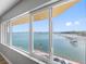 Beautiful view from a large window with sliding glass doors, overlooking the waterfront and city skyline at 100 Bluff View Dr # 404C, Belleair Bluffs, FL 33770