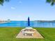 Scenic waterfront view featuring a picnic table and a blue umbrella at 100 Bluff View Dr # 404C, Belleair Bluffs, FL 33770