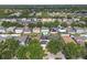 Bird's eye view of homes surrounded by lush trees, showcasing a peaceful neighborhood setting at 10337 River Bream Dr, Riverview, FL 33569