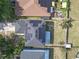 Aerial view of homes with solar panels with backyard patios, mature landscaping, and well-maintained fencing at 10337 River Bream Dr, Riverview, FL 33569