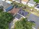 Aerial view of homes with solar panels, fenced yards, and mature trees, emphasizing energy efficiency at 10337 River Bream Dr, Riverview, FL 33569