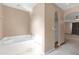 Bathroom featuring a tub and shower, neutral walls, and tile flooring at 10337 River Bream Dr, Riverview, FL 33569