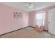 Bedroom with pink walls, carpet, a ceiling fan, and a closet at 10337 River Bream Dr, Riverview, FL 33569