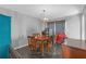 Features a chandelier, wood table with six chairs, geometric curtains, and black floors at 10337 River Bream Dr, Riverview, FL 33569