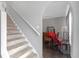 Hallway with carpeted stairs leading to a dining area with hardwood floors at 10337 River Bream Dr, Riverview, FL 33569