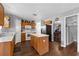 Features oak cabinets, white appliances, laminate countertops, center island and wood floors at 10337 River Bream Dr, Riverview, FL 33569