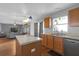 Features oak cabinets, white appliances, laminate countertops, center island and colorful pendant lighting at 10337 River Bream Dr, Riverview, FL 33569