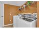 Cozy laundry area with modern white washer and dryer units, plus convenient shelving for storage at 10337 River Bream Dr, Riverview, FL 33569