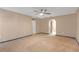 Open living room with neutral walls, a ceiling fan, and doorways to other rooms at 10337 River Bream Dr, Riverview, FL 33569