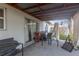 Covered patio area with seating and sliding glass doors leading inside at 10337 River Bream Dr, Riverview, FL 33569