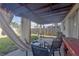 Outdoor patio area with seating and decorative curtains for privacy at 10337 River Bream Dr, Riverview, FL 33569