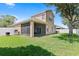 Large grassy backyard with screened patio, outdoor grill, and white vinyl fencing offers privacy and space at 10536 Shady Preserve Dr, Riverview, FL 33579