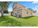 Spacious backyard showing the house's exterior and patio, well-maintained lawn, and white perimeter fencing at 10536 Shady Preserve Dr, Riverview, FL 33579