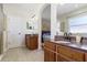 Bathroom with double vanity, granite counters, and a door to connecting bedroom at 10536 Shady Preserve Dr, Riverview, FL 33579