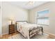 Cozy bedroom with a decorative bed frame and natural light from the window at 10536 Shady Preserve Dr, Riverview, FL 33579