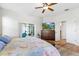 Bedroom with wood floors, a ceiling fan, and sliding door access to outdoor patio at 10536 Shady Preserve Dr, Riverview, FL 33579