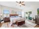 Bedroom with wood floors, ceiling fan, and sliding door access to outdoor patio at 10536 Shady Preserve Dr, Riverview, FL 33579
