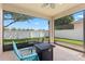 Screened patio featuring a fire pit and seating with a view of the fenced backyard provides outdoor relaxation at 10536 Shady Preserve Dr, Riverview, FL 33579