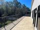 Spacious back deck surrounded by lush greenery, offering a serene outdoor retreat at 10826 Rain Lilly Pass, Land O Lakes, FL 34638