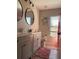Bathroom featuring dual vanities, sleek fixtures, with a toilet and window in view at 10826 Rain Lilly Pass, Land O Lakes, FL 34638