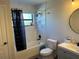 Modern bathroom features a shower-tub combination, marbled tile, stylish vanity, and updated fixtures at 10826 Rain Lilly Pass, Land O Lakes, FL 34638
