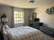 Comfortable bedroom with a large window, stylish decor, and a serene ambiance at 10826 Rain Lilly Pass, Land O Lakes, FL 34638
