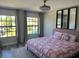 Bright bedroom features a plush pink bed frame, modern ceiling fan, and large windows for plenty of natural light at 10826 Rain Lilly Pass, Land O Lakes, FL 34638