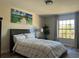 Comfortable bedroom with a large window, stylish decor, and a serene ambiance at 10826 Rain Lilly Pass, Land O Lakes, FL 34638