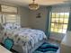 Cozy bedroom with large window, stylish headboard, and colorful decor at 10826 Rain Lilly Pass, Land O Lakes, FL 34638