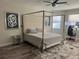 This main bedroom features a four post bed frame and a computer work station at 10826 Rain Lilly Pass, Land O Lakes, FL 34638