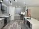 Spacious kitchen featuring stainless steel appliances, gray cabinets, a kitchen island, and modern countertops at 10826 Rain Lilly Pass, Land O Lakes, FL 34638
