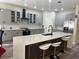 Modern kitchen features stainless steel appliances, a center island, and stylish gray cabinetry at 10826 Rain Lilly Pass, Land O Lakes, FL 34638