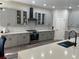 Well-equipped kitchen with stainless steel appliances, gray cabinets, and ample counter space at 10826 Rain Lilly Pass, Land O Lakes, FL 34638