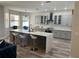 A kitchen is complete with quartz countertops, gray cabinets, a kitchen island, and stainless steel appliances at 10826 Rain Lilly Pass, Land O Lakes, FL 34638