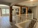 Open-concept living area with exposed wood beams, wood floors and large windows at 10826 Rain Lilly Pass, Land O Lakes, FL 34638
