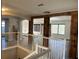Open-concept living area with exposed wood beams, wood floors and large windows at 10826 Rain Lilly Pass, Land O Lakes, FL 34638