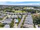 Aerial view of a community featuring single Gathering homes, golf course and a lake at 1130 Hominy Hill Dr, Trinity, FL 34655