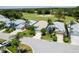 Aerial view of a well-manicured home with lush landscaping and a pristine golf course backdrop at 1130 Hominy Hill Dr, Trinity, FL 34655