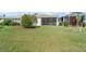 Spacious backyard with lush green lawn and screened in patio for outdoor enjoyment at 1130 Hominy Hill Dr, Trinity, FL 34655