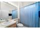 Bright bathroom with a vanity, toilet and shower with curtain at 1130 Hominy Hill Dr, Trinity, FL 34655